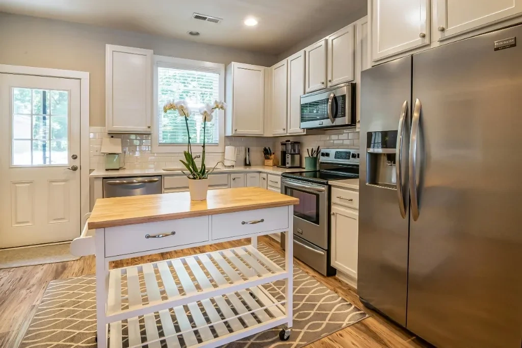 Spotless modern gourmet kitchen with stainless steel appliances and island, cleaned by Splash Maids