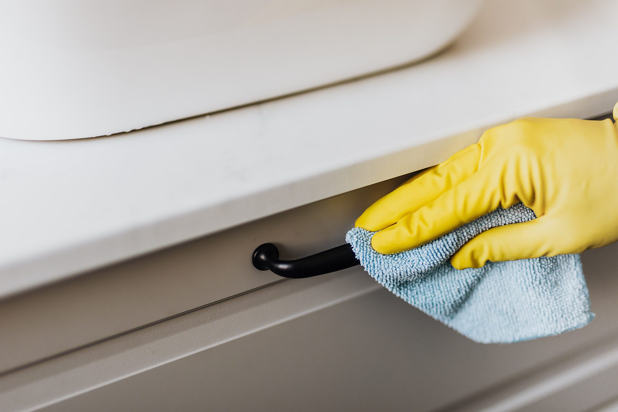 Expert house cleaning service in Toronto, residential maid cleaning a surface near the sink