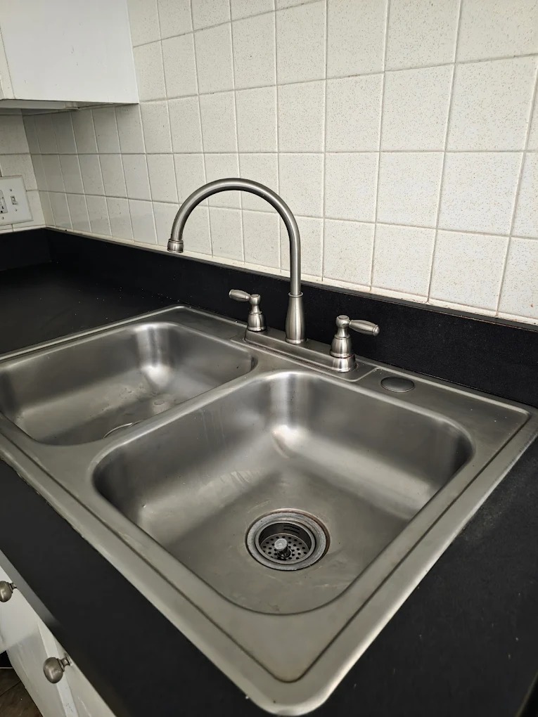 Spotless kitchen sink and countertops after professional sanitization